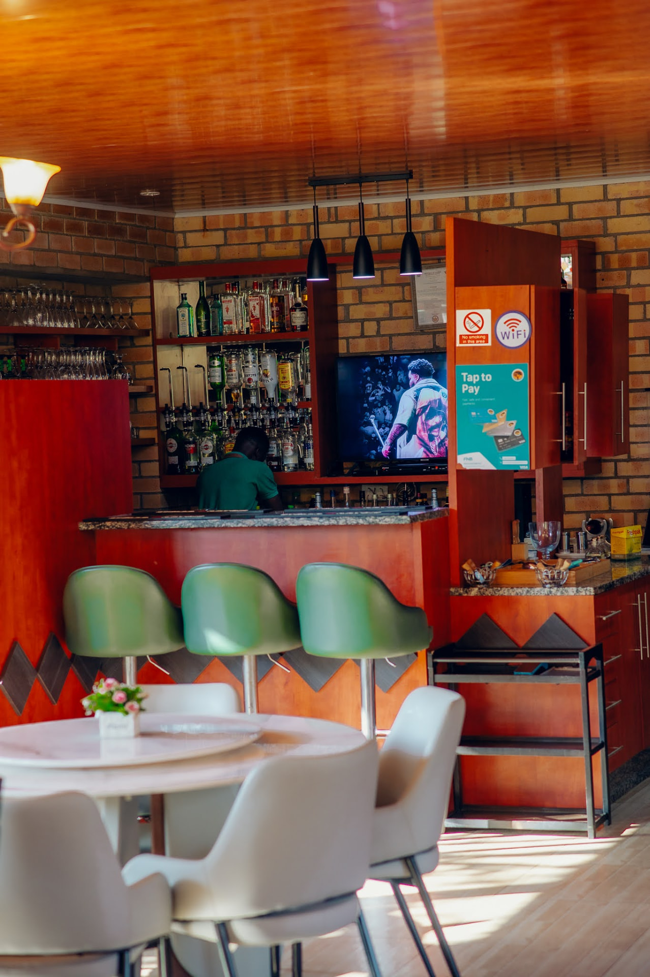 Lounge seating and the fully stocked bar counter at Kiwi Cafe