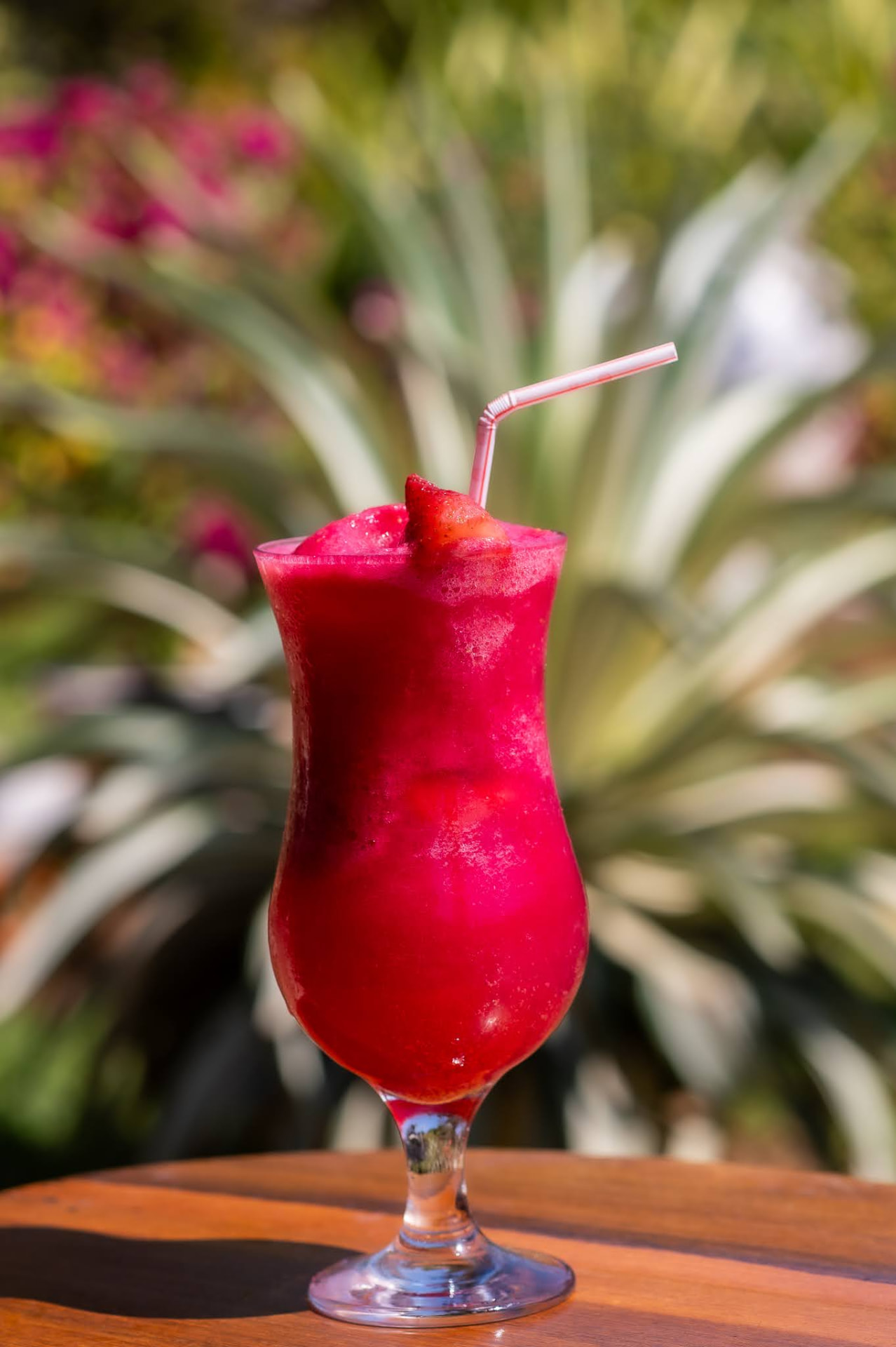 Frozen strawberry daiquiri garnished with a strawberry in the garden